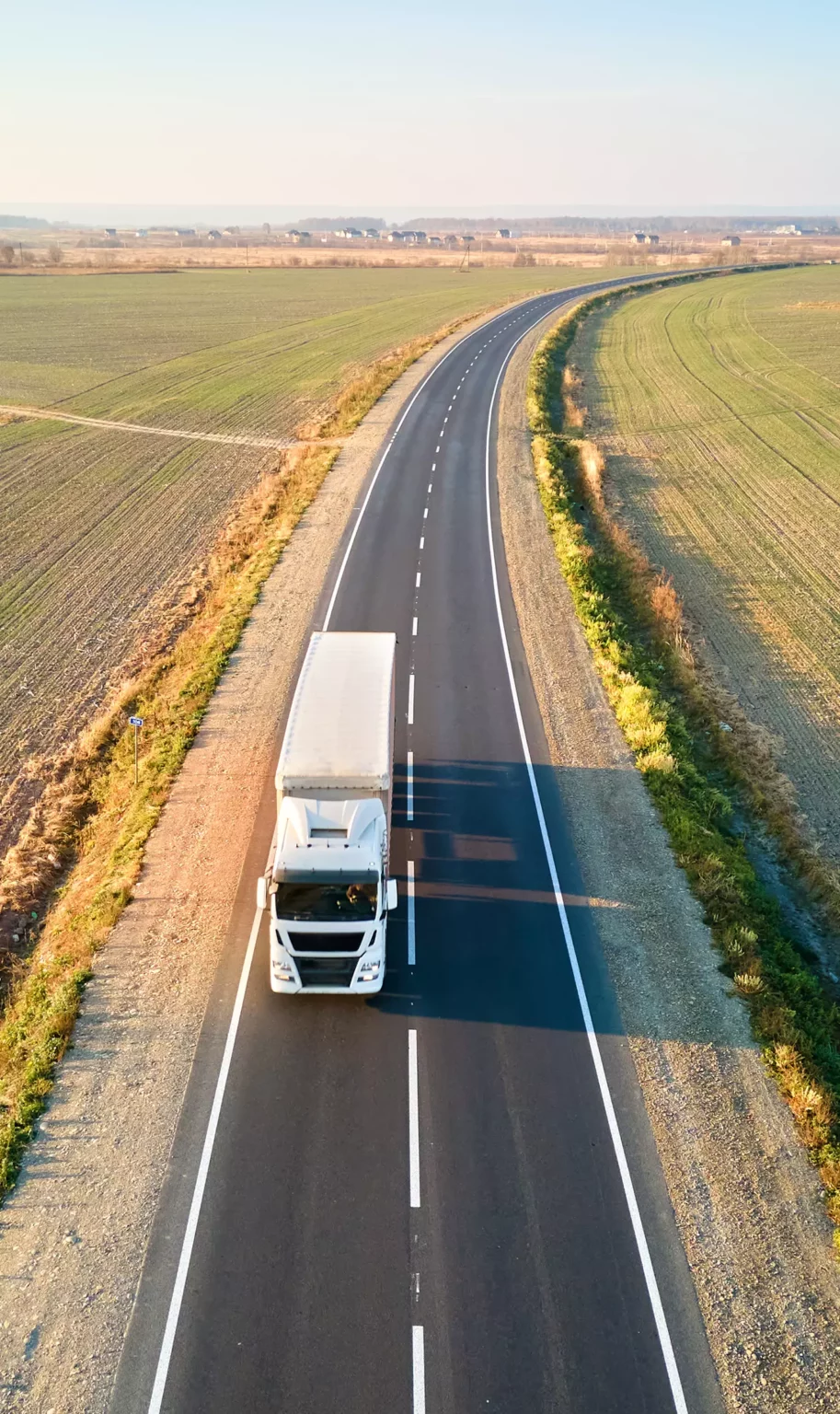 Hercules Moving Solutions - Packing and Storage - Long Distance Relocation - Truck Driving through Agriculture Field
